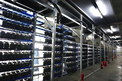 Industrial-scale mining farm with rows of hosted mining machines